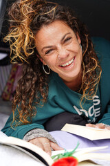 Catalonian independence day. Sant jordi day. Smiling woman with a rose reading a book looking at camera