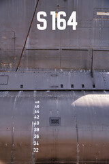 Close-up of the Portuguese Navy submarine Barracuda, showcasing its hull markings and depth gauge....