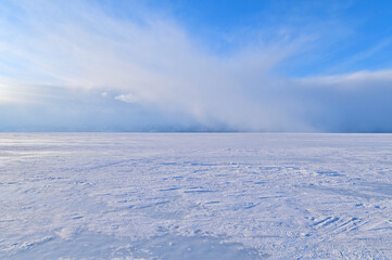 Fototapeta na wymiar Beautiful Scenery of Frozen Lake Baikal Covered with Snow During Snowstorm
