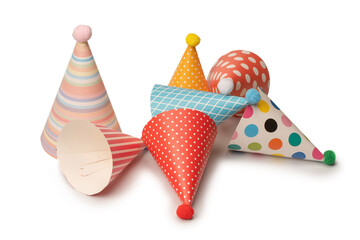 A group of bright and colorful birthday caps isolated on a white background.