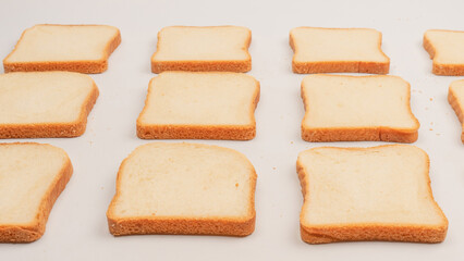 Delicious bread slices isolated on a white background, top view.