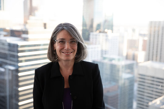 Portrait Of Woman Standing Against Window