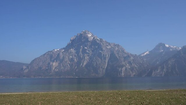 Seebr&uuml;cke, Aueck, Traunkirchen, Austria - March 2023: Beautiful city view. Mountain Lake. Lake among the mountains. Huts in the mountains near the forest lake.