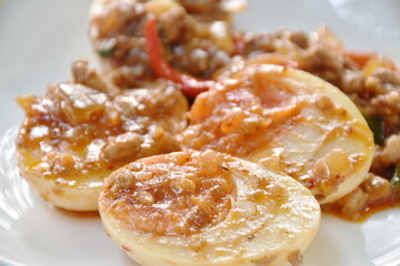 slice boiled egg dressing spicy fried chop pork and curry on plate