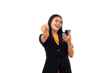 Fototapeta premium Happy young asian business woman pointing on camera while holding a cell phone. Isolated on white