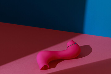 Sex toy for women also called vacuum clitoral stimulator for satisfaction on pink background  - obrazy, fototapety, plakaty
