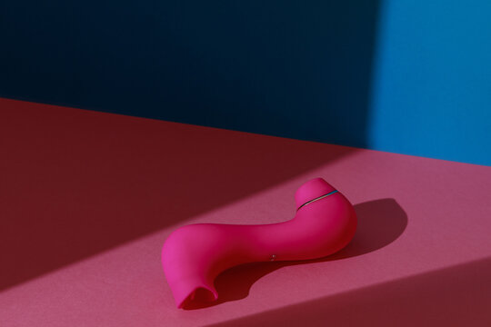 Sex toy for women also called vacuum clitoral stimulator for satisfaction on pink background 