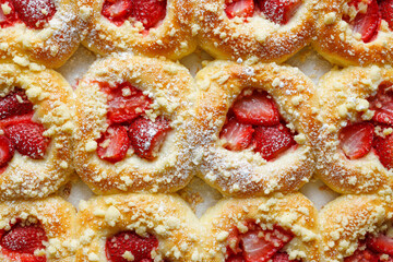 Sweet buns with the addition of strawberries and butter crumble, close up