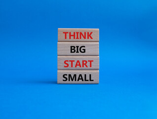 Think big start small symbol. Concept words Think big start small on wooden blocks. Beautiful blue background. Business and Think big start small concept. Copy space