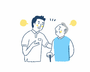 笑顔で話すシニア男性と介護スタッフ