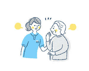 笑顔で話すシニア女性と介護スタッフ