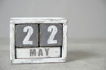 May 22 calendar made wooden cubes gray background.With an empty space for your text.