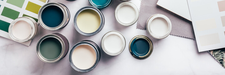 Tiny sample paint cans during house renovation, process of choosing paint for the walls, different...