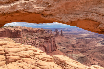Scenic view through Mesa Arch near Moab, Canyonlands National Park, San Juan County, Southern Utah, USA. Looking at natural pothole arch rock formation on the eastern edge of Island in the Sky Mesa