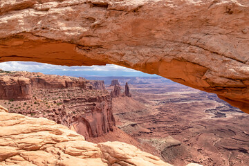 Scenic view through Mesa Arch near Moab, Canyonlands National Park, San Juan County, Southern Utah, USA. Looking at natural pothole arch rock formation on the eastern edge of Island in the Sky Mesa