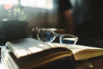 A close up shot of reading glasses on book