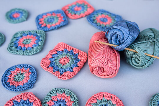 Closeup of a hook inserted into yarn skeins with different croch