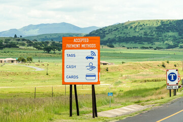 road sign or signage with accepted forms of payment tags, cash and cards to pay on a toll road in...