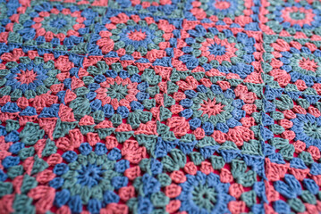 Granny squares crochet afghan in red, blue and green colors.