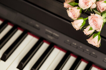 Romantic holiday composition with pink roses on piano. Piano lessons, music education, hobby,...
