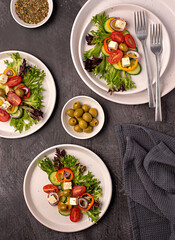 Food photography of  feta salad, greek, tomato, cucumber, onion, lettuce, sauce, bell, pepper, cheese, olive, vegetables
