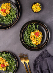 Food photography of salad, salsa, mango, avocado, shrimp, prawn, arugula, rocket, vegetable; onion; sauce, chili