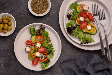 Food photography of  feta salad, greek, tomato, cucumber, onion, lettuce, sauce, bell, pepper, cheese, olive, vegetables