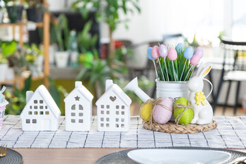 Key to house of cozy home with Easter decor with rabbit and eggs on table of kitchen. Building,...