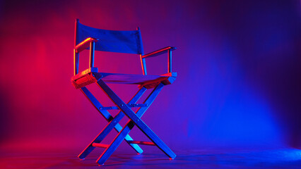 Black Director chair in red and blue light color with black background