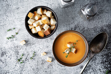 Sweet potato soup with croutons and thyme leaves