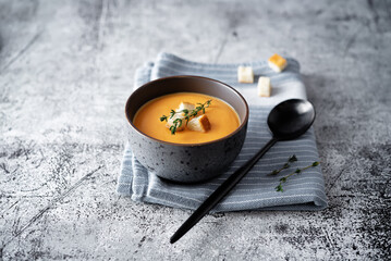 Sweet potato soup with croutons and thyme leaves