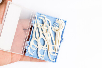 Oral Device : Dental flossers on white paper background