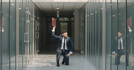 Fototapeta na wymiar Happy businessman dancing in office building. Flexibility and grace in business. Human emotions concept. Office, success, professional, happiness, expression concepts