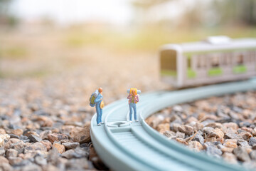 Miniature people : Couple backpacker walking on the railway