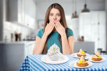 Funny young Woman Eating tasty cake