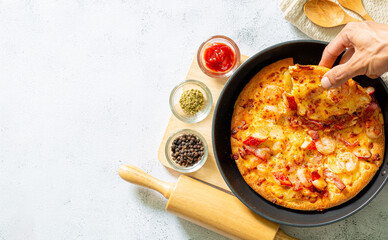 pizza in pan,Fresh raw pizza with mushrooms, cherry tomatoes , Basil and Parmesan in a round pan on a white background with copy space. Homemade pizza before baking