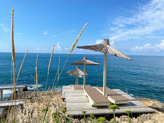 Fototapeta premium Rocky secluded beach and blue sea in summer sunny day.