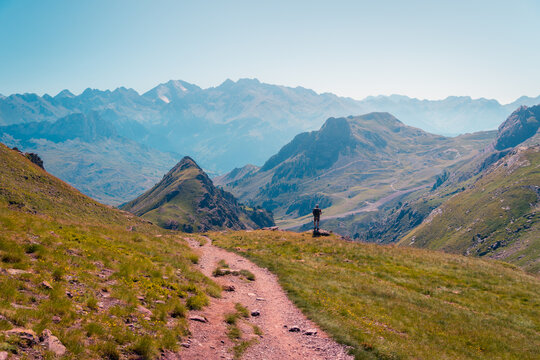 Traveler walking on path in mountains
