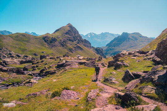 Traveler walking on path in mountains