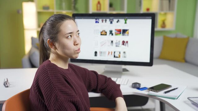 Thoughtful e-commerce owner asian young business woman.
Asian young woman with e-commerce thinking of creative and ingenious ideas.

