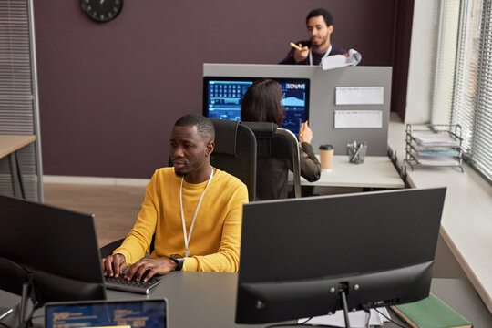 High angle view at people working in open office in IT development company, copy space