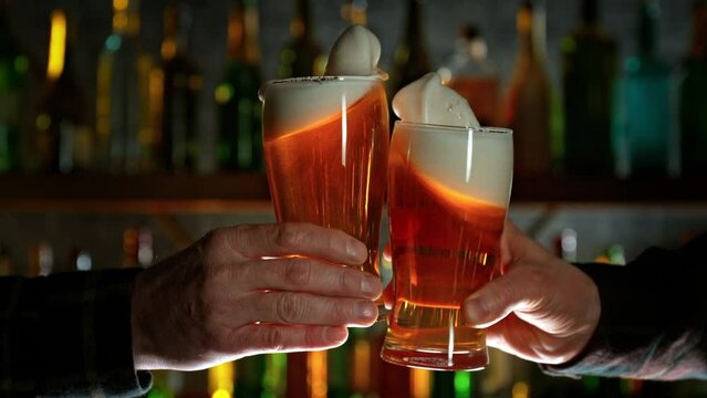 Super Slow Motion Shot of Beer Glasses Cheering in Bar at 1000fps.