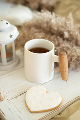 Breakfast in bed. A cup of tea and goodies on a tray