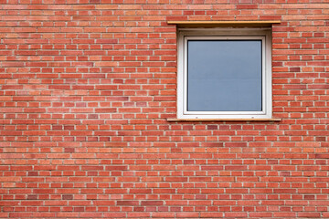 discreet aluminum window in brick wall