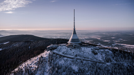 A bird's eye view of snow-covered Jested at sunrise. Photographed on the Jested ridge by drone....