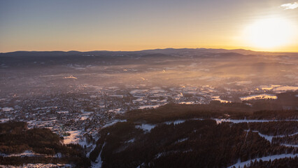 A bird's eye view of snowy Liberec at sunrise. Photographed on Jested Ridge by drone in winter.