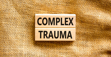 Complex trauma symbol. Concept words Complex trauma on wooden block. Beautiful canvas table canvas...