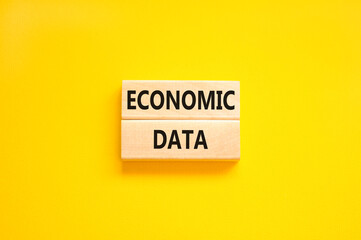 Economic data symbol. Concept words Economic data on wooden block. Beautiful yellow table yellow background. Business economic data concept. Copy space.