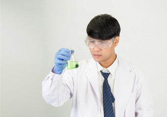 Asian man student scientist or doctor look hand holding in reagent mixing laboratory In a science...