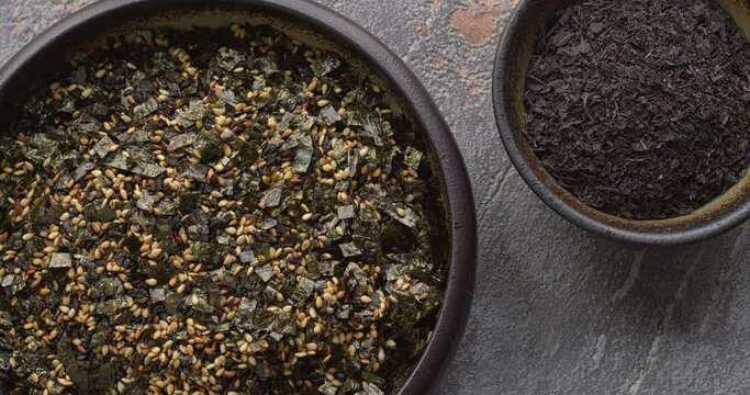 Vegan furikake and Yukari rice seasonings. Japanese cuisine condiments in bowl. Table spin.